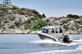 The UMS 865CAB aluminum boat cruising along a rocky shoreline.