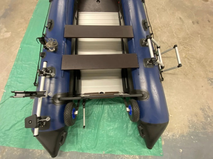 Inflatable boat parts seen from above: aluminum floor, two bench seats, transom wheels, rod holders and a boarding ladder on the tubes