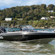 A UMS 655 DC aluminum boat floating in shallow waters.
