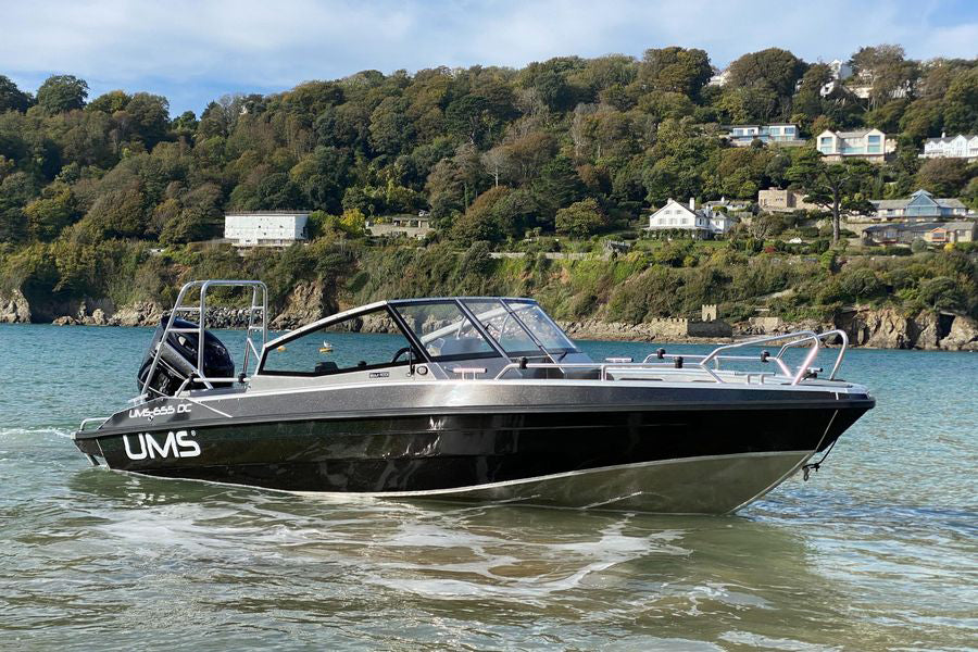 A UMS 655 DC aluminum boat floating in shallow waters.