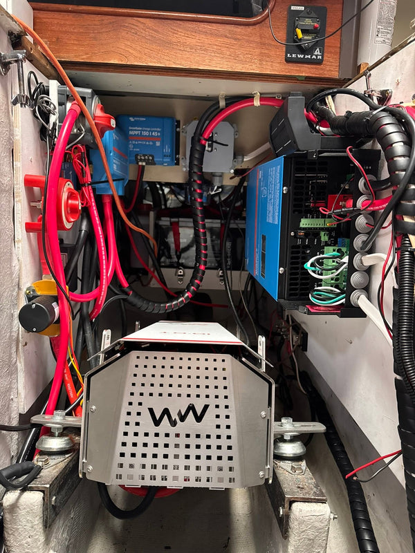 WaterWorld drive under its stainless guard in the old engine bay, with Victron electronics above