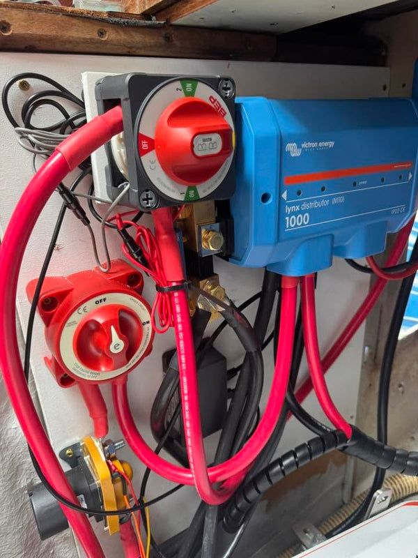 Battery switches and a Victron DC-DC charger with heavy red cabling