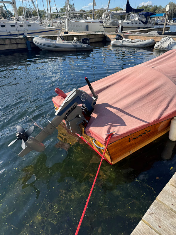 Canadian Challenger under its cover at the dock with the Momentum M10 lowered into the water