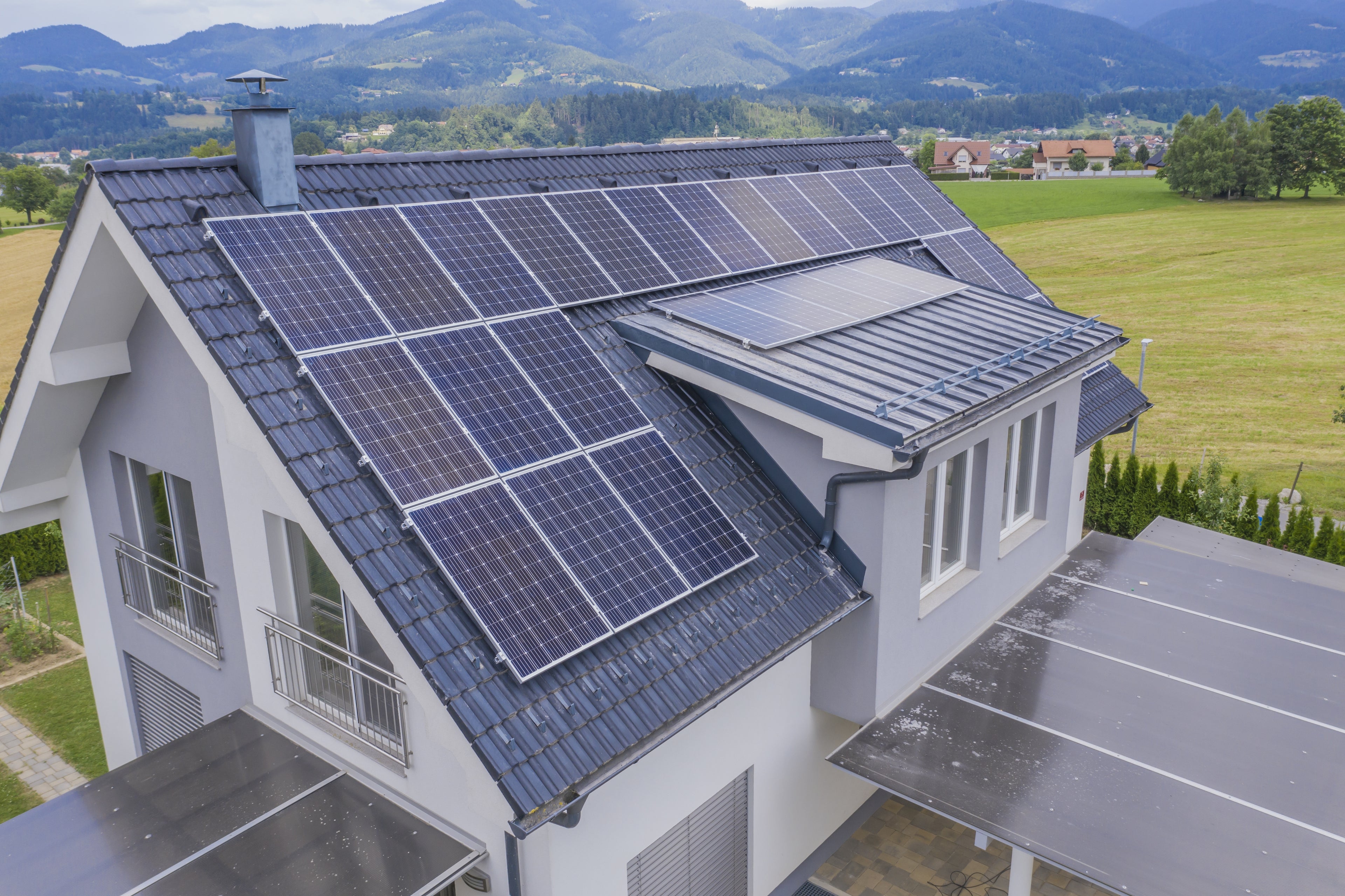 House with solar panels on the roof in a rural setting