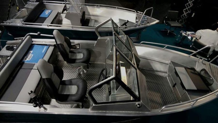 An overhead view of the Aluminum Boat UMS 485 DC, highlighting its spacious seating arrangement, dual consoles, and durable aluminum flooring, designed for comfort and functionality.