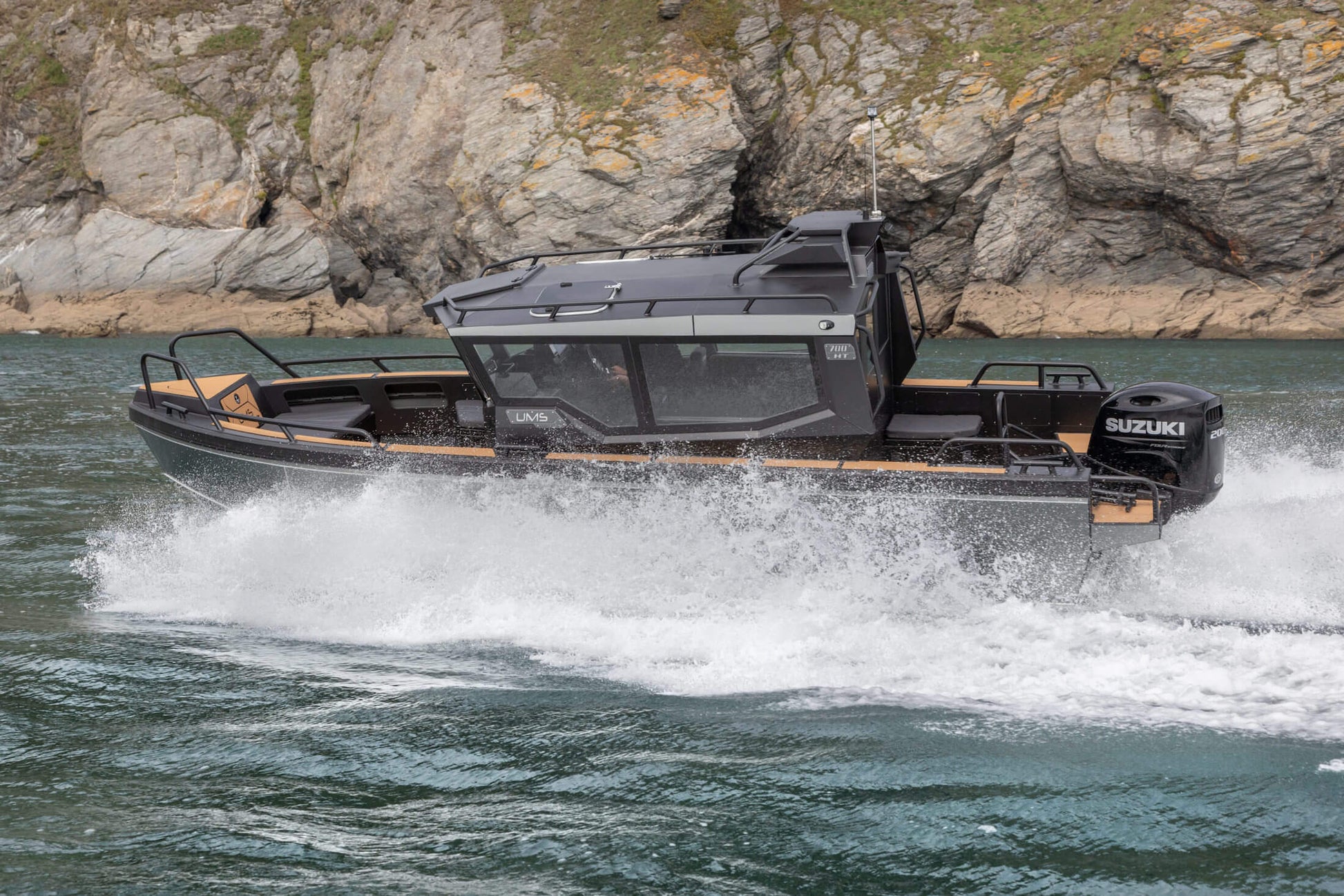 The UMS 700HT aluminum boat powering through the water at high speed.
