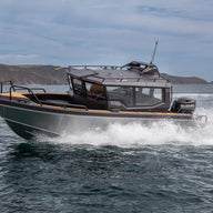 A sleek UMS 700HT aluminum boat cutting through the water at high speed.