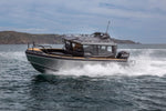 A sleek UMS 700HT aluminum boat cutting through the water at high speed.