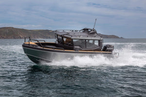 A sleek UMS 700HT aluminum boat cutting through the water at high speed.