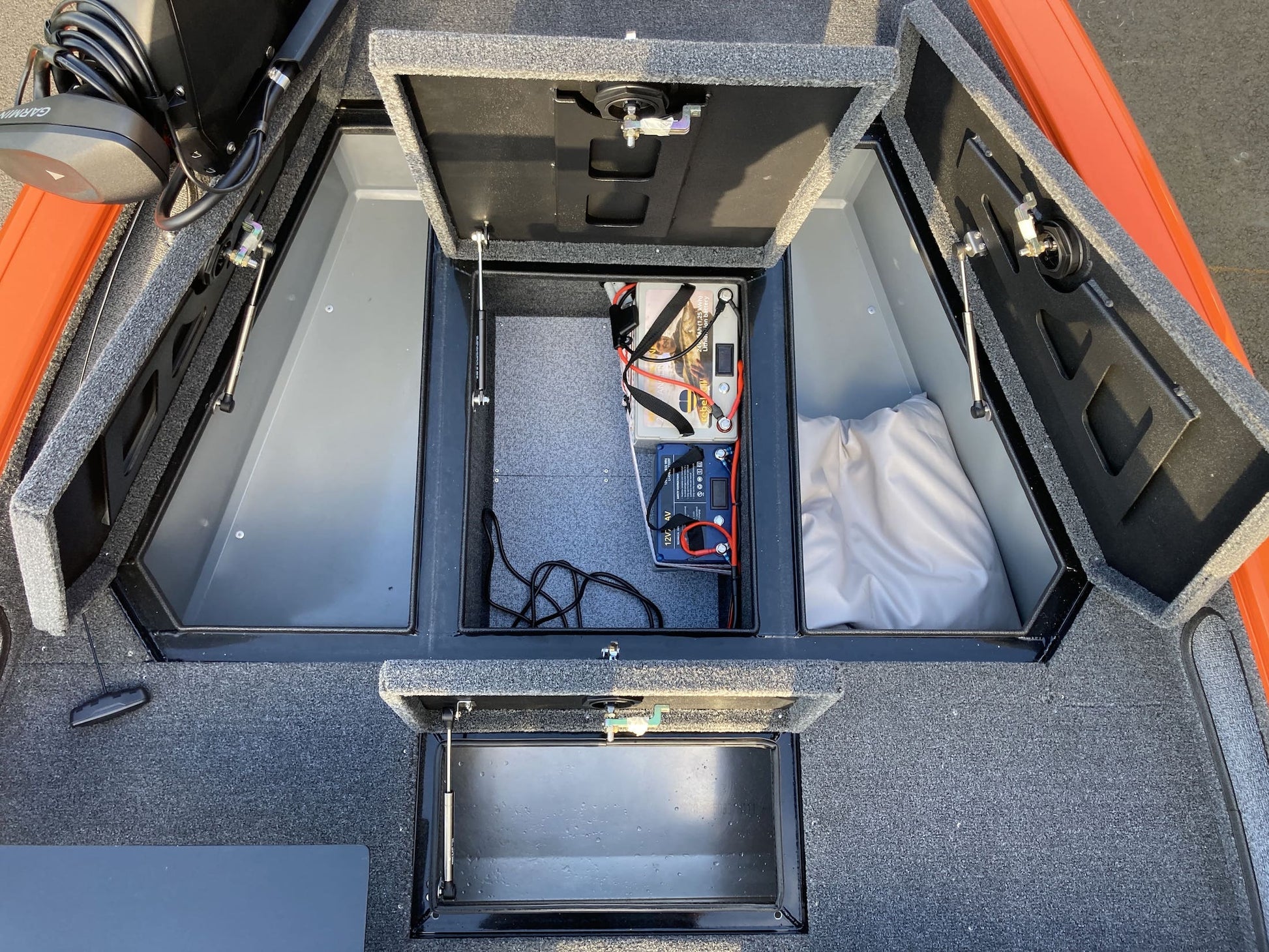 Fishing compartments in aluminum boat.