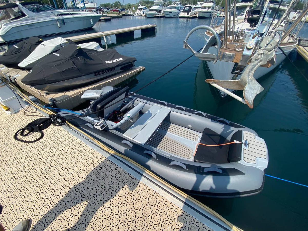 GALA Atlantis A360Q RIB at a marina dock with an ePropulsion Navy 6.0 Evo electric outboard, side console and bench seat