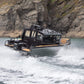 The UMS 700HT aluminum boat powering through the water at high speed.