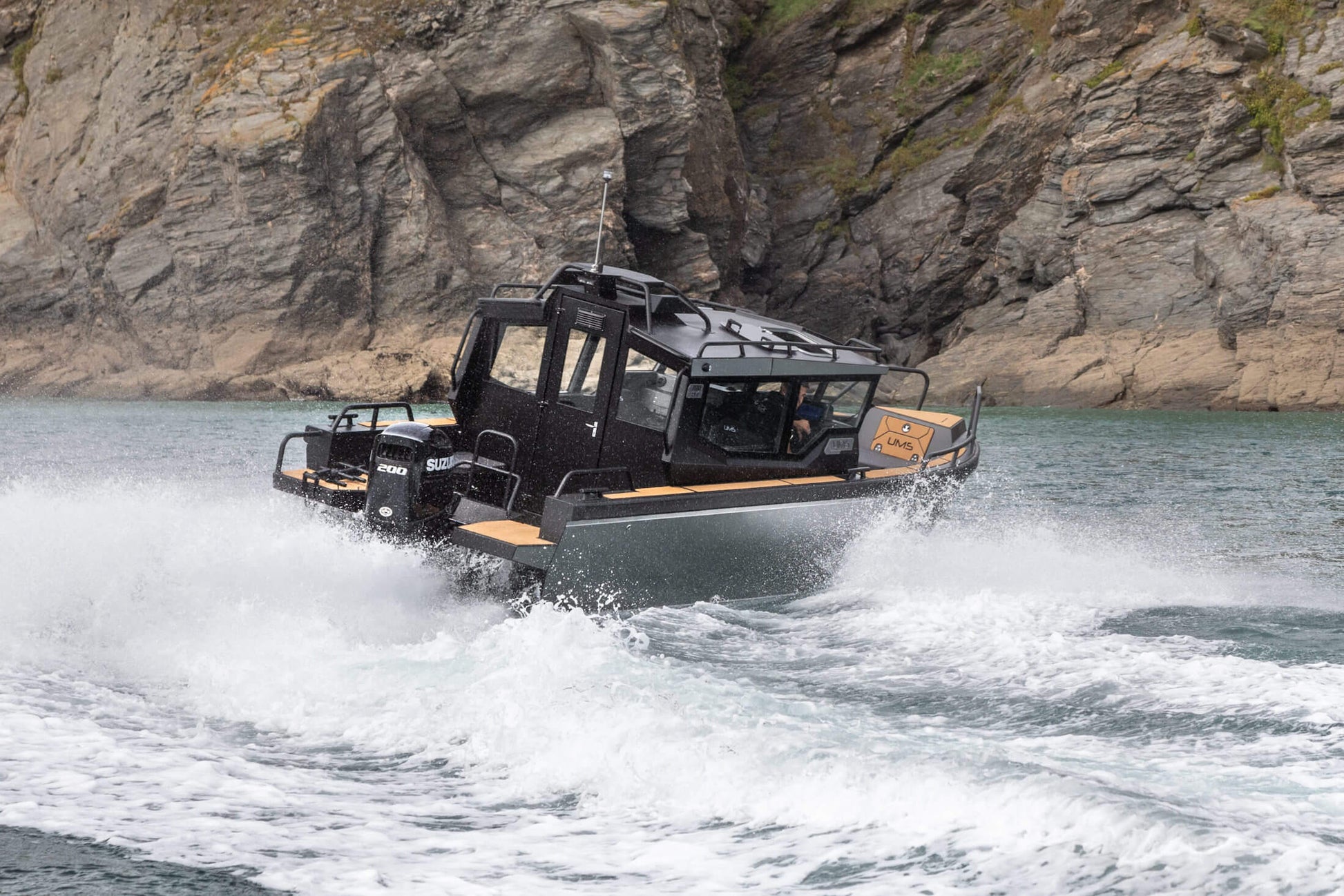 The UMS 700HT aluminum boat powering through the water at high speed.