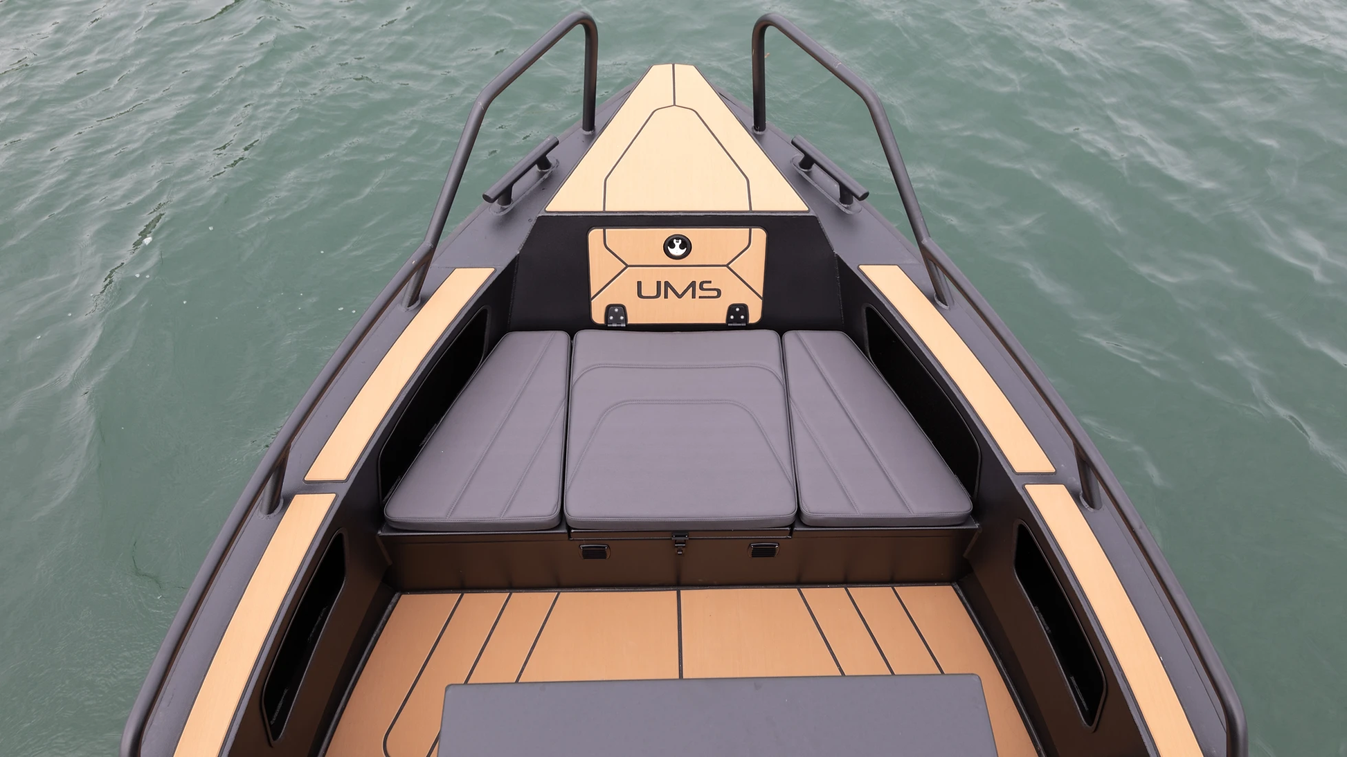 The bow of the UMS 700HT aluminum boat, featuring stylish and comfortable seating with vinyl coverings.
